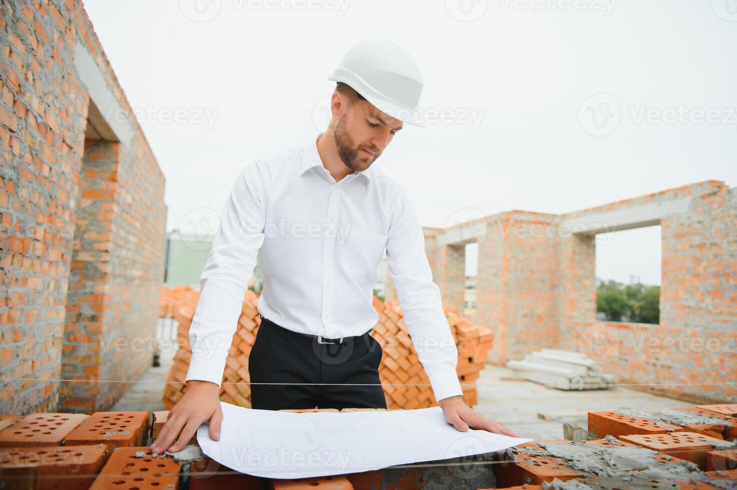 Engineering Consulting People on construction site holding blueprint in his hand. Building inspector. Construction site check drawing and business workflow of new building. photo