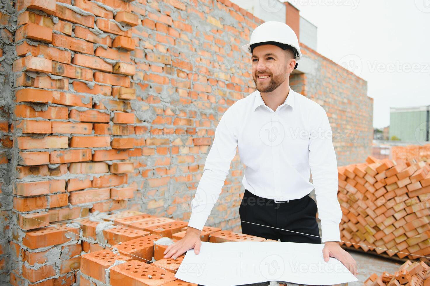 A construction worker controlling the construction of roof structures on construction site photo