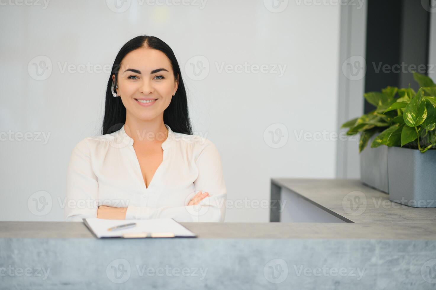 Portrait of beautiful receptionist near counter in hotel photo