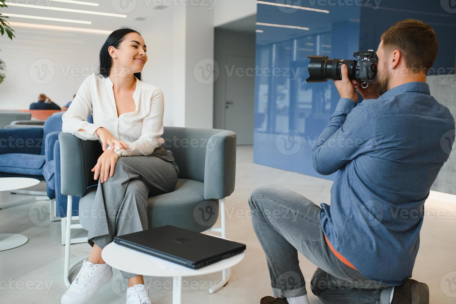 Young beautiful model posing for professional photographer in studio. photo