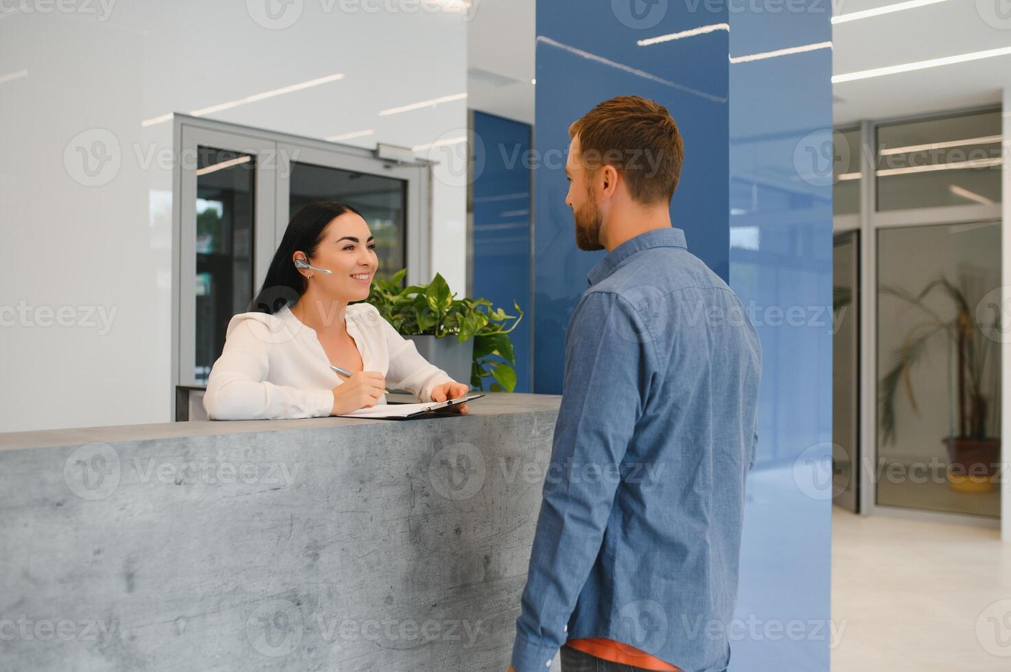 Excellent service. Nice friendly woman talking to the client while standing at the reception. photo