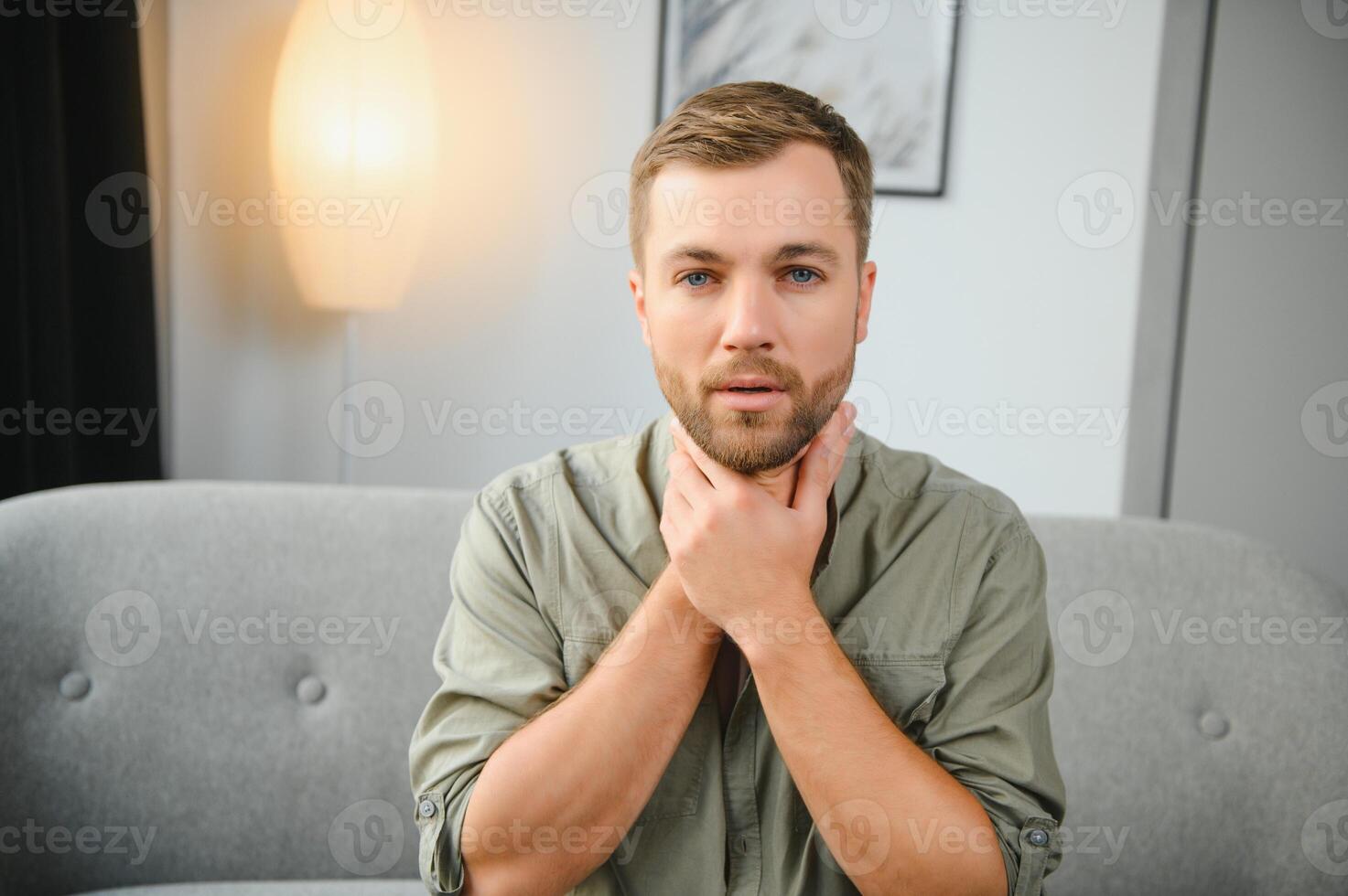 Sore throat, men with pain in neck in home interior, health problems concept photo