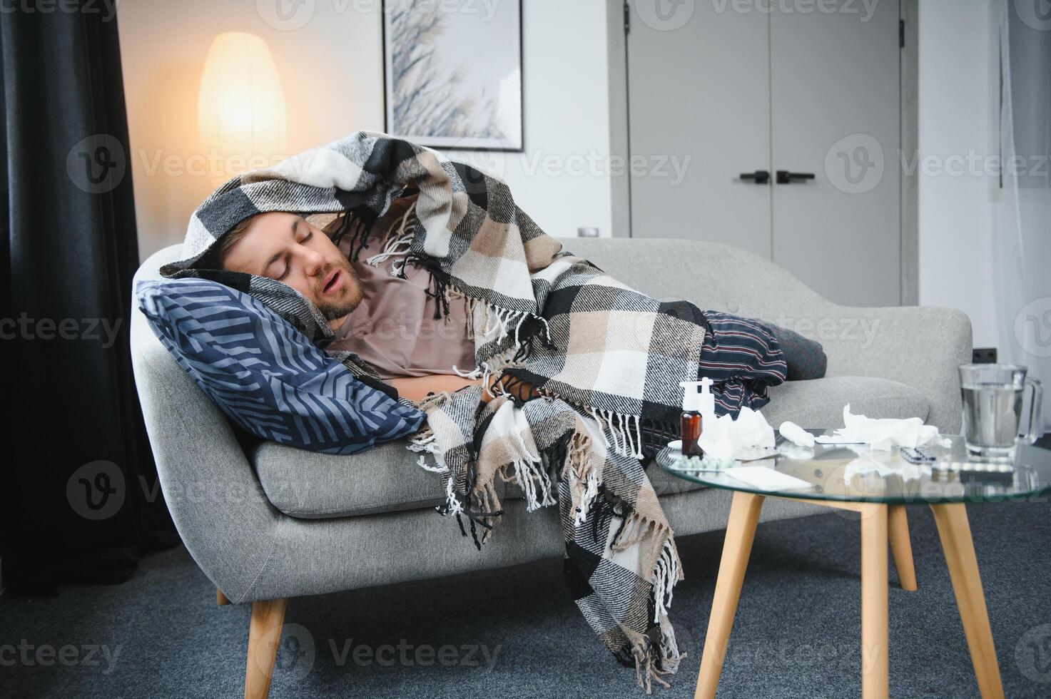 Sick man lying on sofa at home. photo