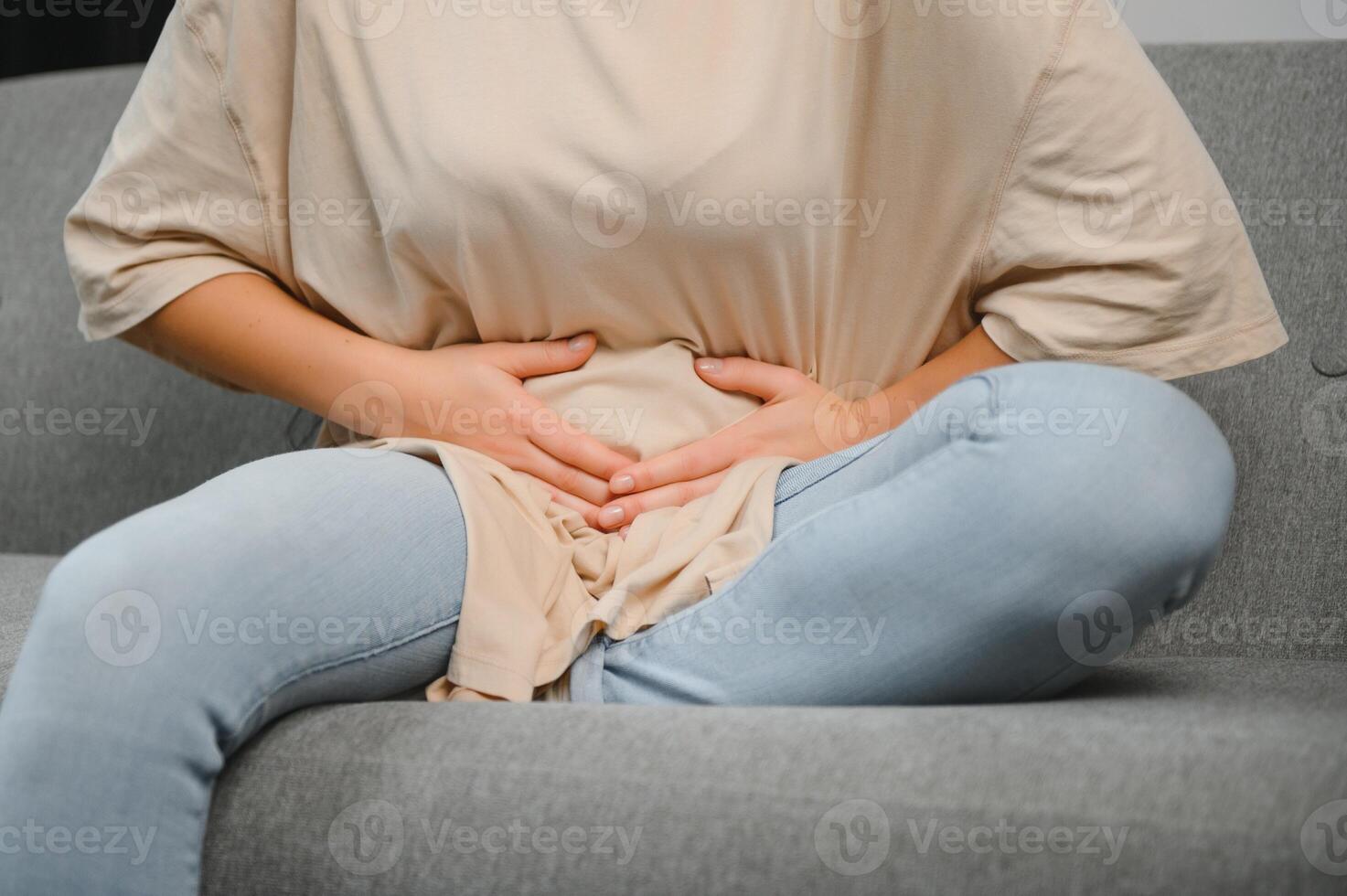 Menstrual pain, woman with stomachache suffering from pms at home, endometriosis, cystitis and other diseases of the urinary system. photo