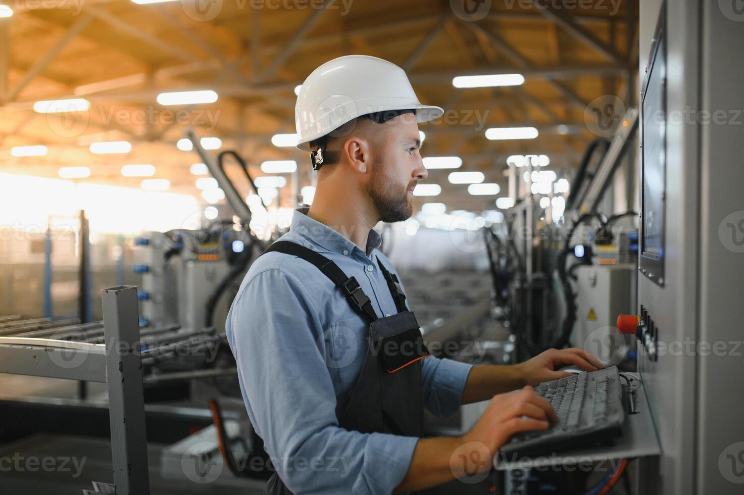 Factory for aluminum and PVC windows and doors production. Manual worker assembling PVC windows and doors photo