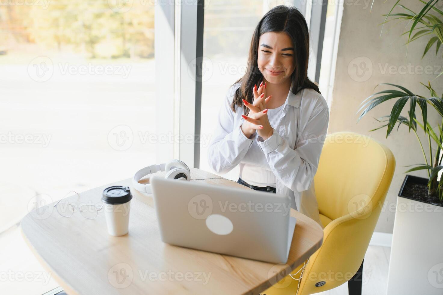 Beautiful Caucasian woman dreaming about something while sitting with portable net-book in modern cafe bar, young charming female freelancer thinking about new ideas during work on laptop computer photo