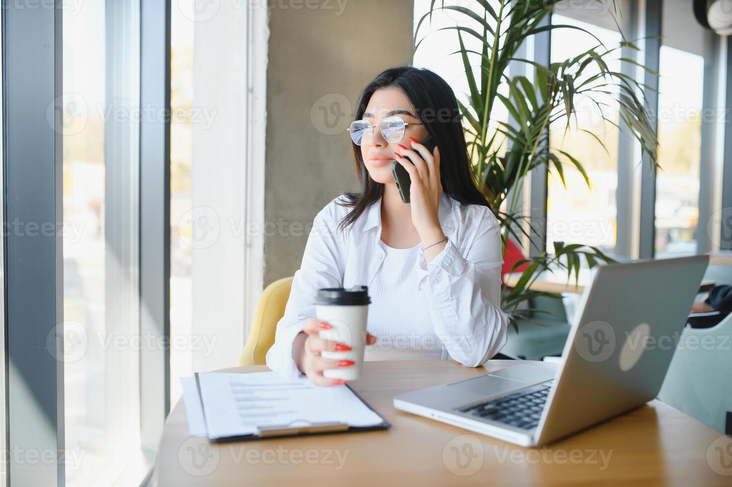 Beautiful Caucasian woman dreaming about something while sitting with portable net-book in modern cafe bar, young charming female freelancer thinking about new ideas during work on laptop computer photo