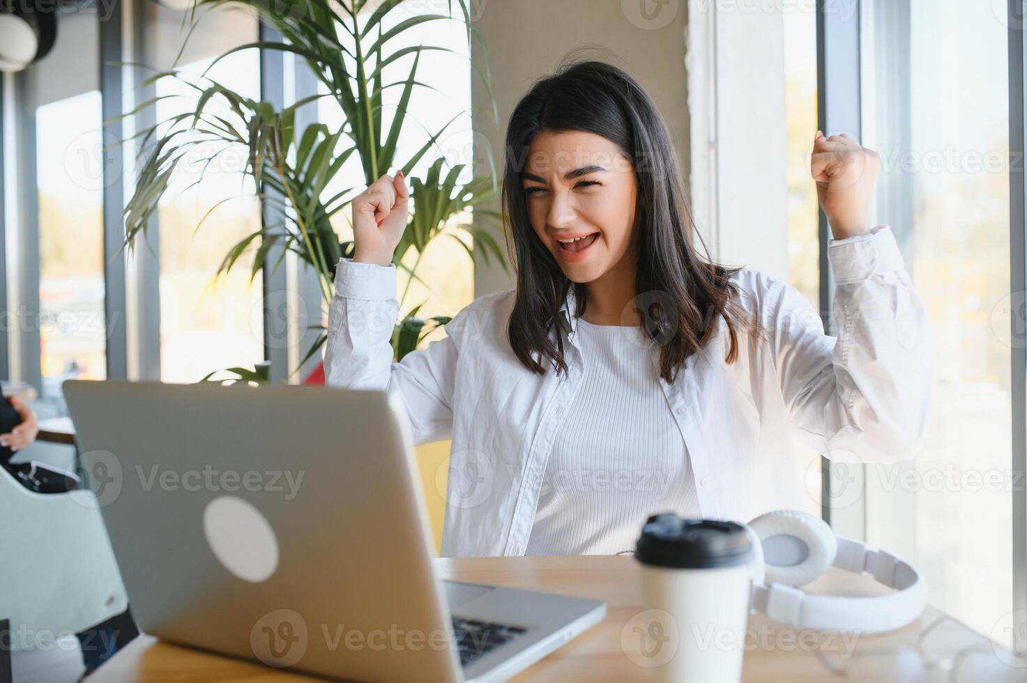 Beautiful Caucasian woman dreaming about something while sitting with portable net-book in modern cafe bar, young charming female freelancer thinking about new ideas during work on laptop computer photo