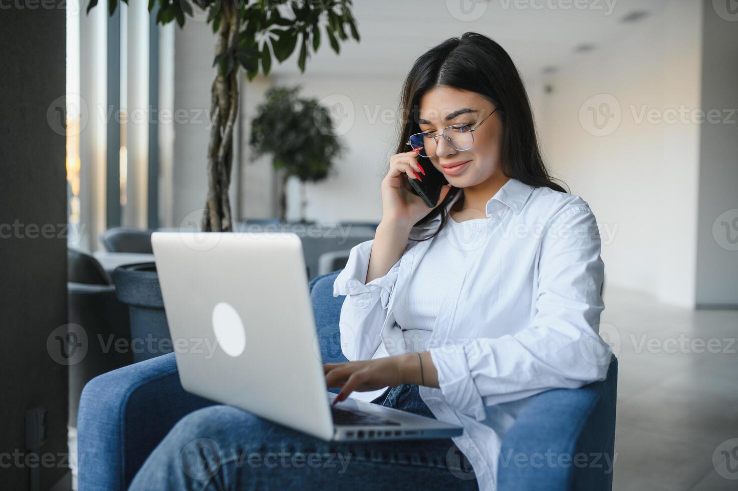 Beautiful Caucasian woman dreaming about something while sitting with portable net-book in modern cafe bar, young charming female freelancer thinking about new ideas during work on laptop computer photo