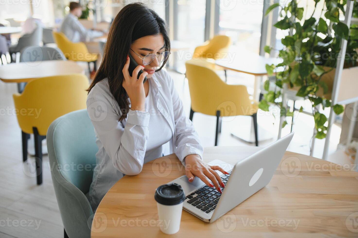 Beautiful Caucasian woman dreaming about something while sitting with portable net-book in modern cafe bar, young charming female freelancer thinking about new ideas during work on laptop computer photo