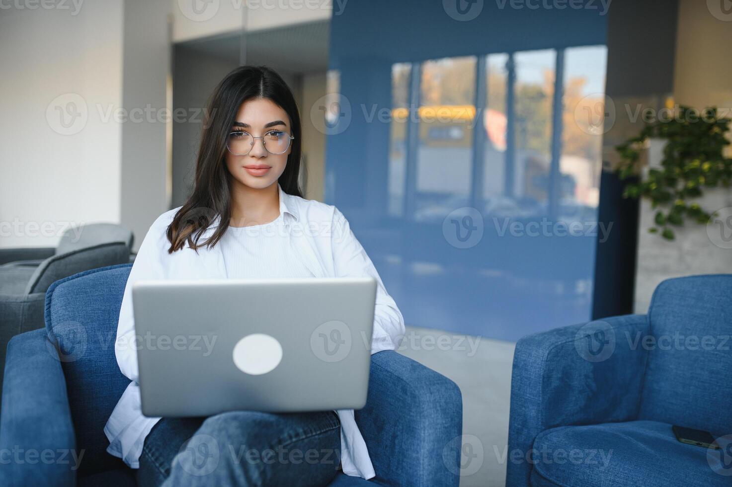 Beautiful Caucasian woman dreaming about something while sitting with portable net-book in modern cafe bar, young charming female freelancer thinking about new ideas during work on laptop computer photo