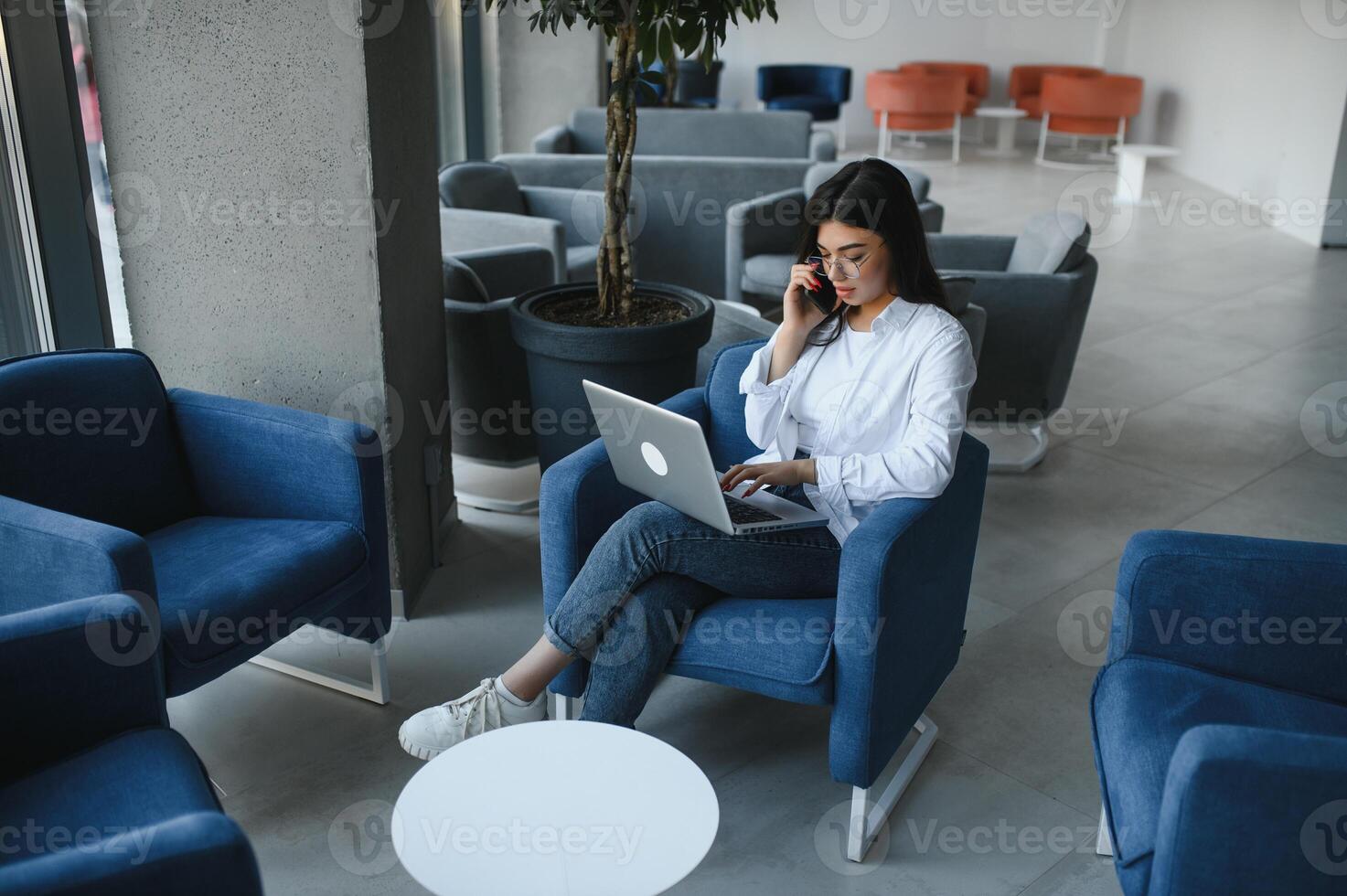 Beautiful Caucasian woman dreaming about something while sitting with portable net-book in modern cafe bar, young charming female freelancer thinking about new ideas during work on laptop computer photo