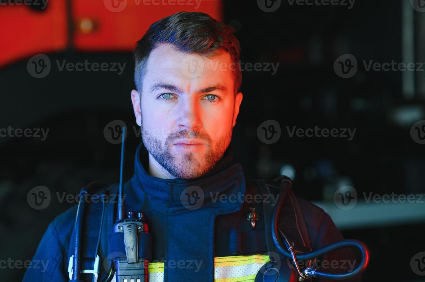 Photo of fireman with gas mask and helmet near fire engine