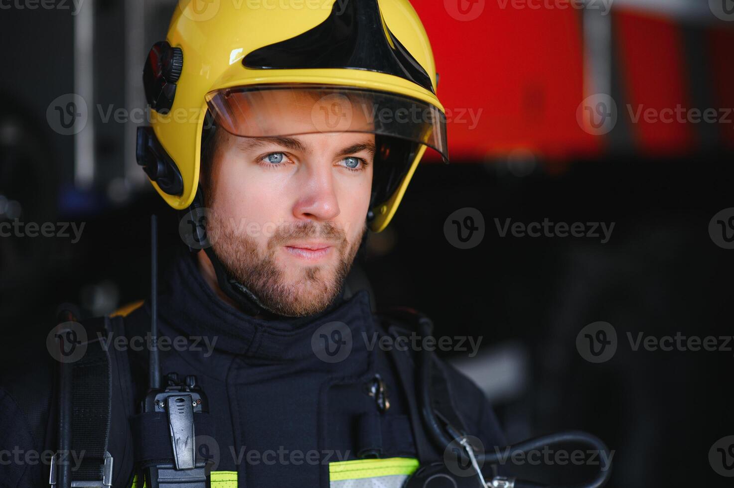 Photo of fireman with gas mask and helmet near fire engine