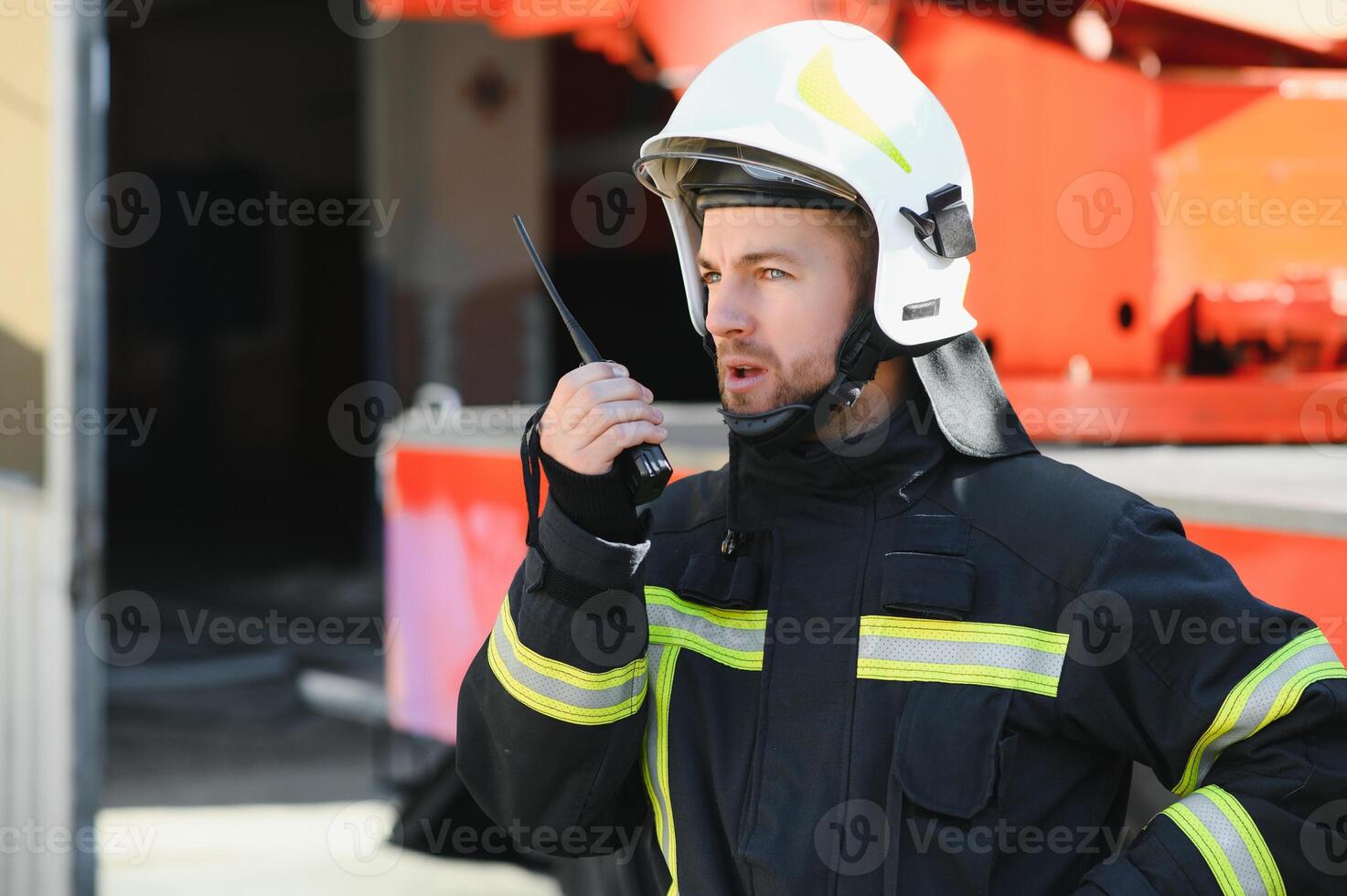 Photo of fireman with gas mask and helmet near fire engine
