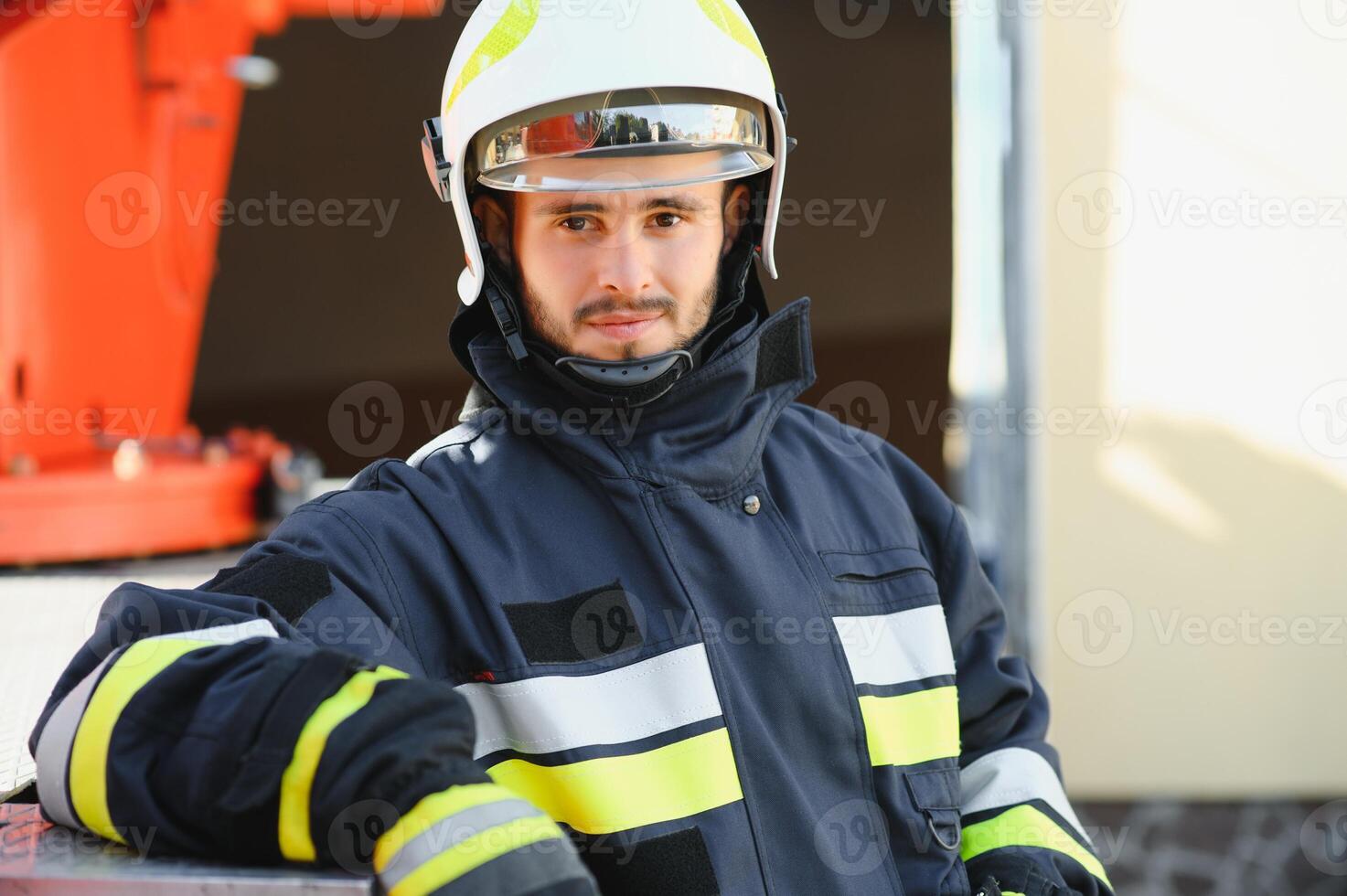 Fireman firefighter in action standing near a firetruck. Emergency safety. Protection, rescue from danger. photo