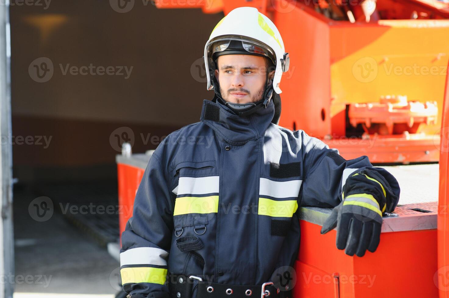 Photo of fireman with gas mask and helmet near fire engine
