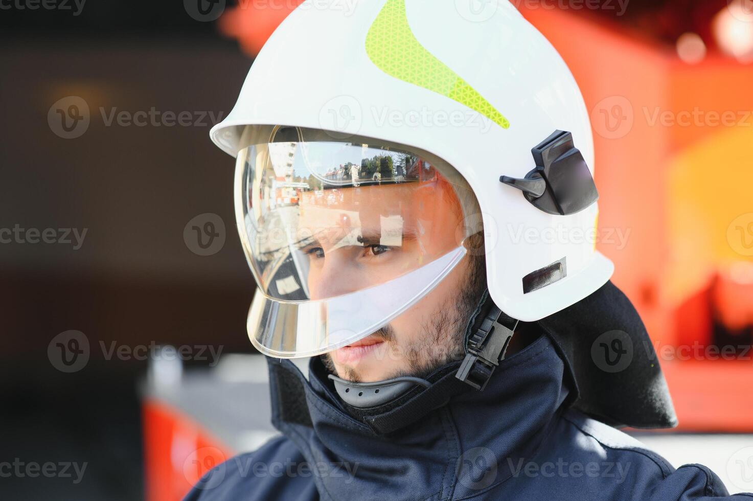 Photo of fireman with gas mask and helmet near fire engine
