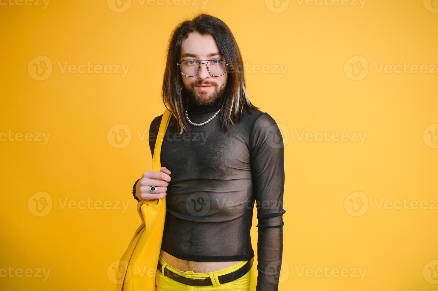 Gay man on a colored background in the studio. The concept of the LGBTQ community. Equality. photo