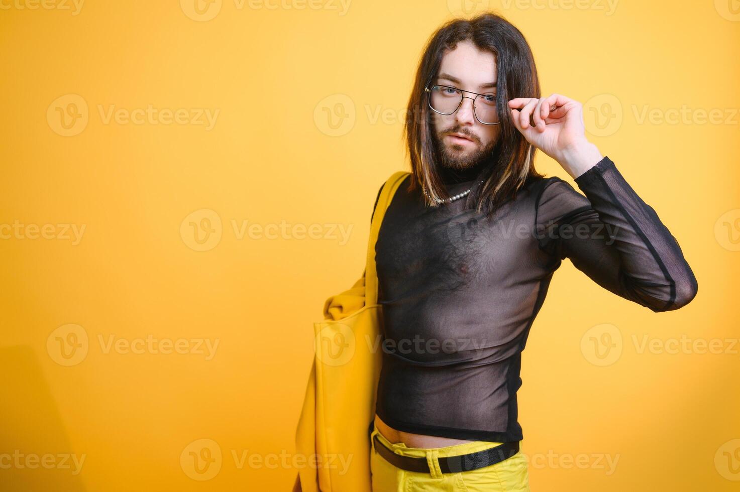 Gay man hold rainbow striped flag isolated on colored background studio portrait. People lifestyle fashion lgbtq concept photo