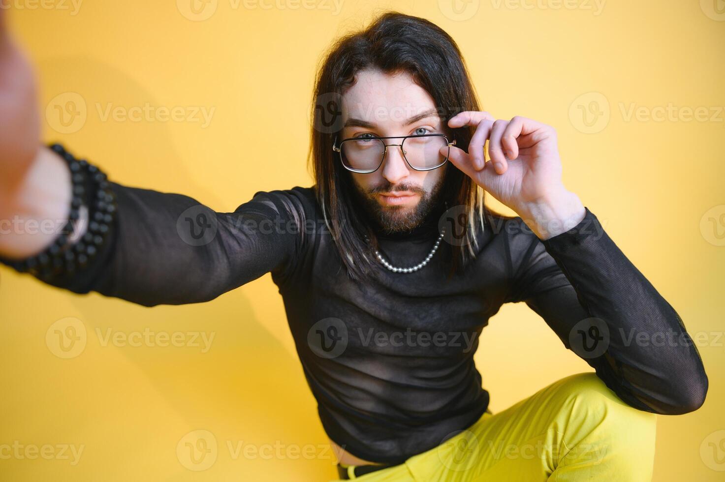 Gay man on a colored background in the studio. The concept of the LGBTQ community. Equality. photo