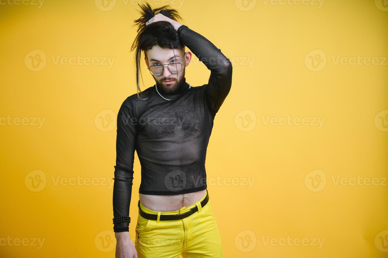 Gay man on a colored background in the studio. The concept of the LGBTQ community. Equality. photo