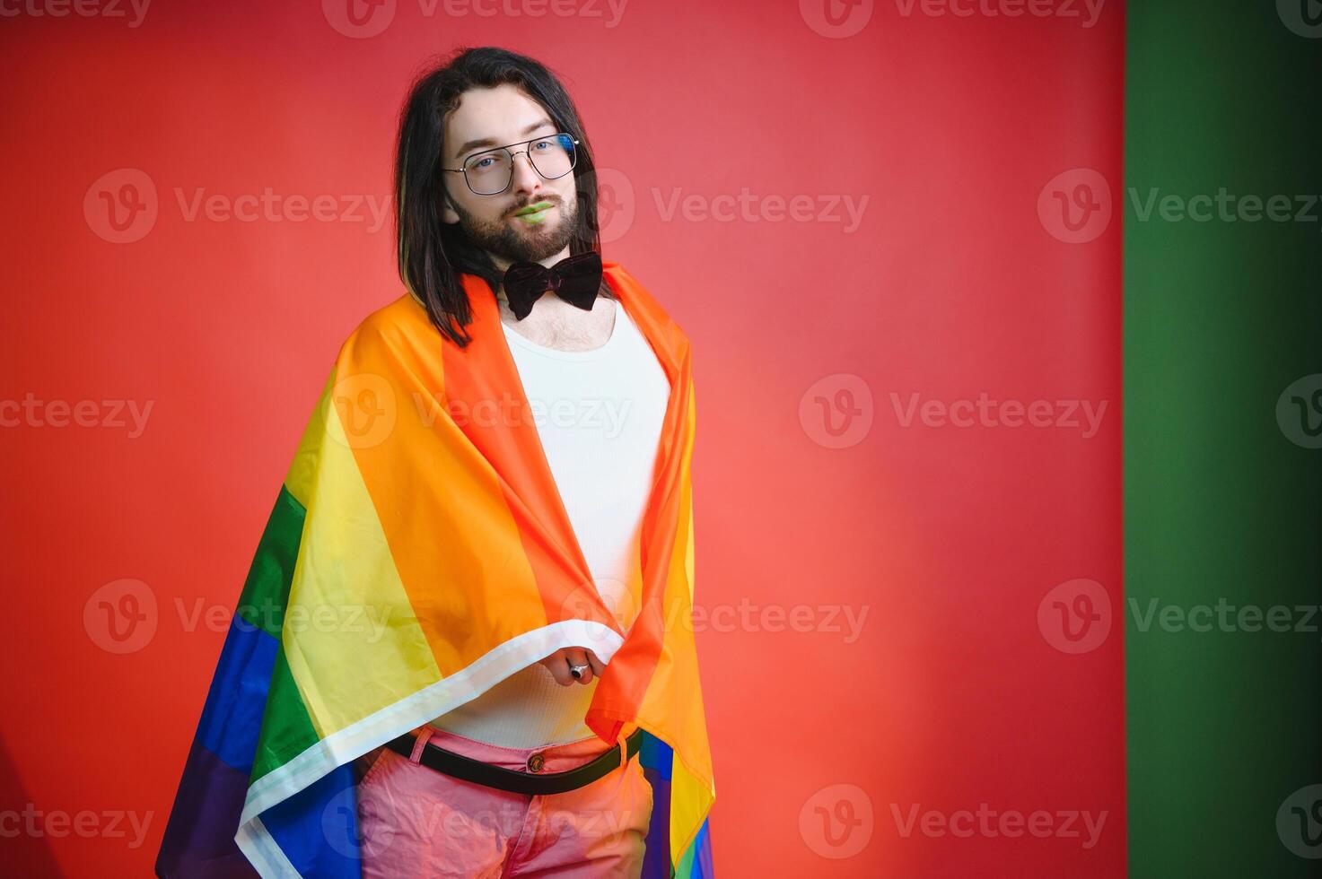 Youth transgender LGBT with Rainbow flag on shoulder isolated color background. gender expression pride and equality concept. photo