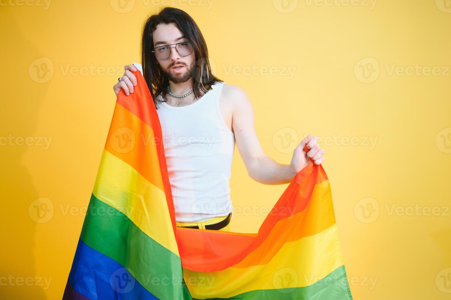 Youth transgender LGBT with Rainbow flag on shoulder isolated color background. gender expression pride and equality concept. photo