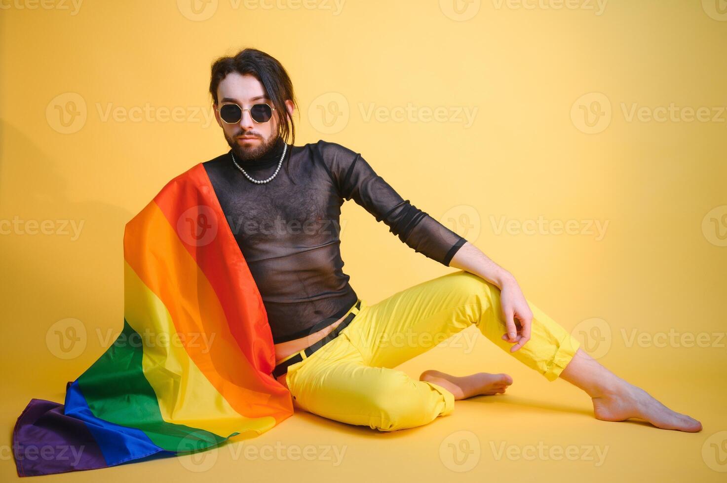 Youth transgender LGBT with Rainbow flag on shoulder isolated color background. gender expression pride and equality concept. photo
