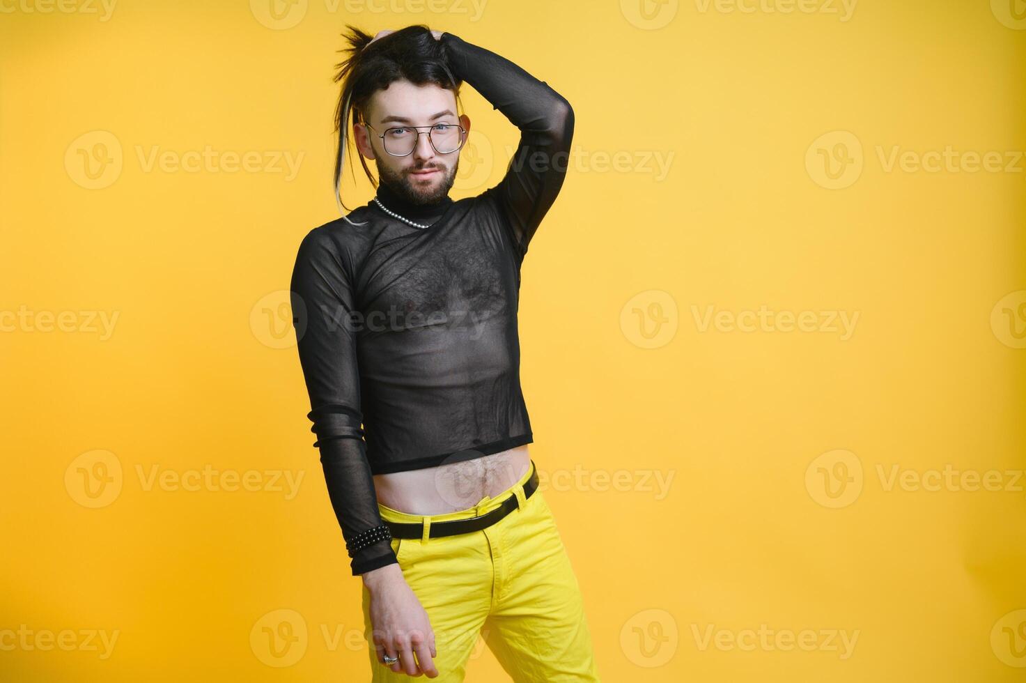 Young, handsome gay man on a colored background in the studio. LGBT concept. photo