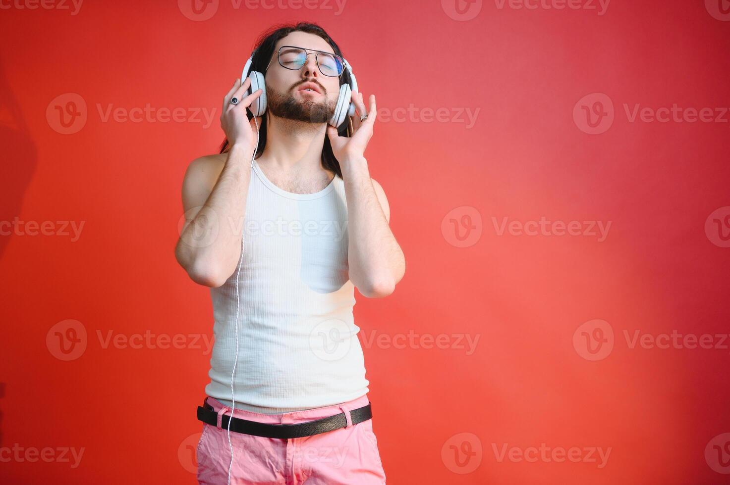 Cheerful gay man listening music. photo