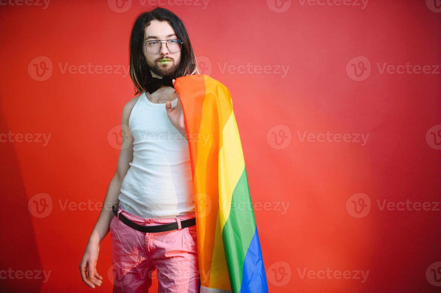 Gay man on a colored background in the studio. The concept of the LGBTQ community. Equality. photo