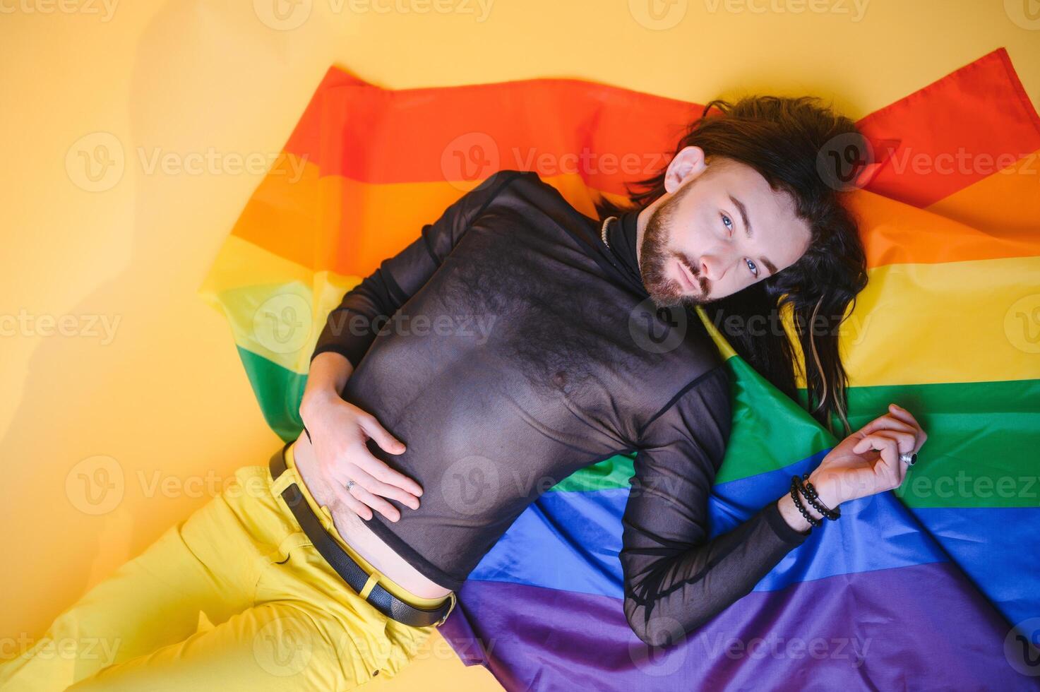 Youth transgender LGBT with Rainbow flag on shoulder isolated color background. gender expression pride and equality concept. photo