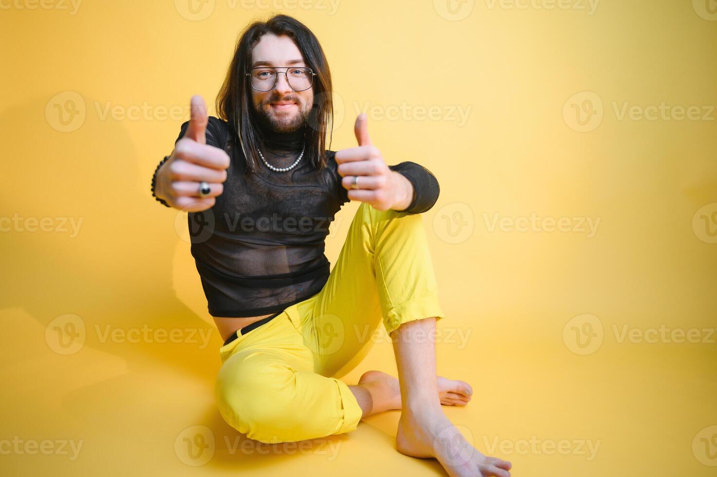 Young, handsome gay man on a colored background in the studio. LGBT concept. photo