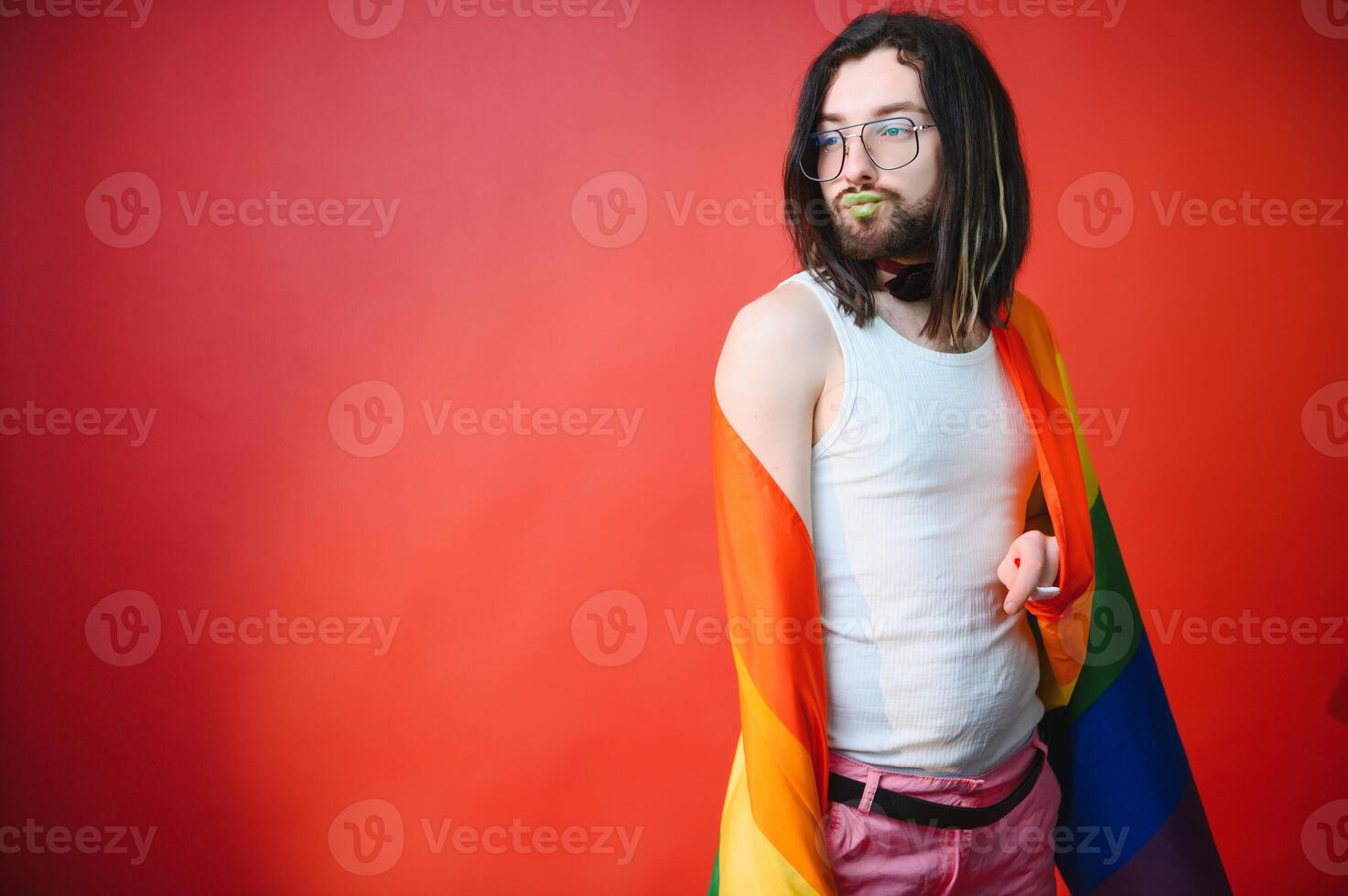 Youth transgender LGBT with Rainbow flag on shoulder isolated color background. gender expression pride and equality concept. photo