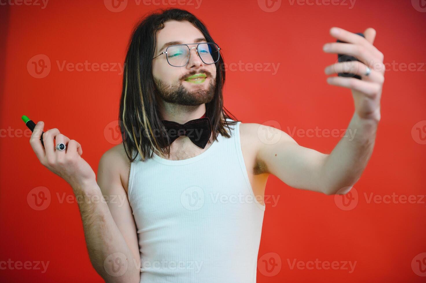 Young, handsome gay man on a colored background in the studio. LGBT concept. photo