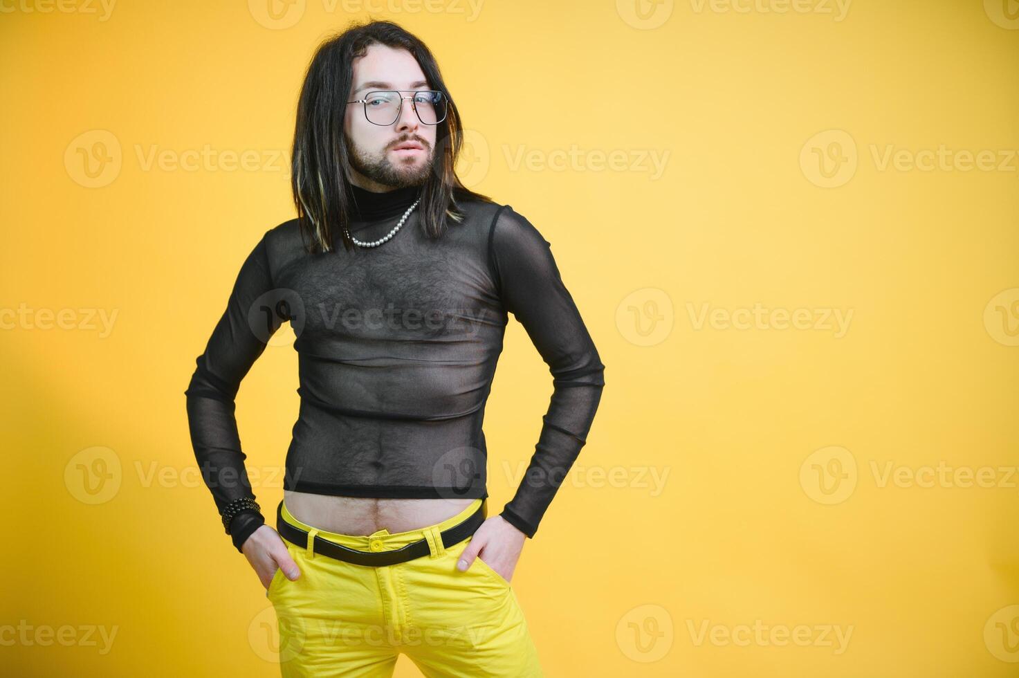 Young, handsome gay man on a colored background in the studio. LGBT concept. photo
