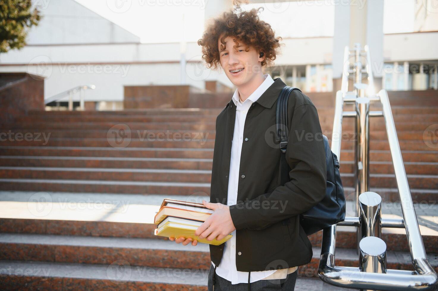Excited student having break between classes near university, smiling to camera outdoors photo