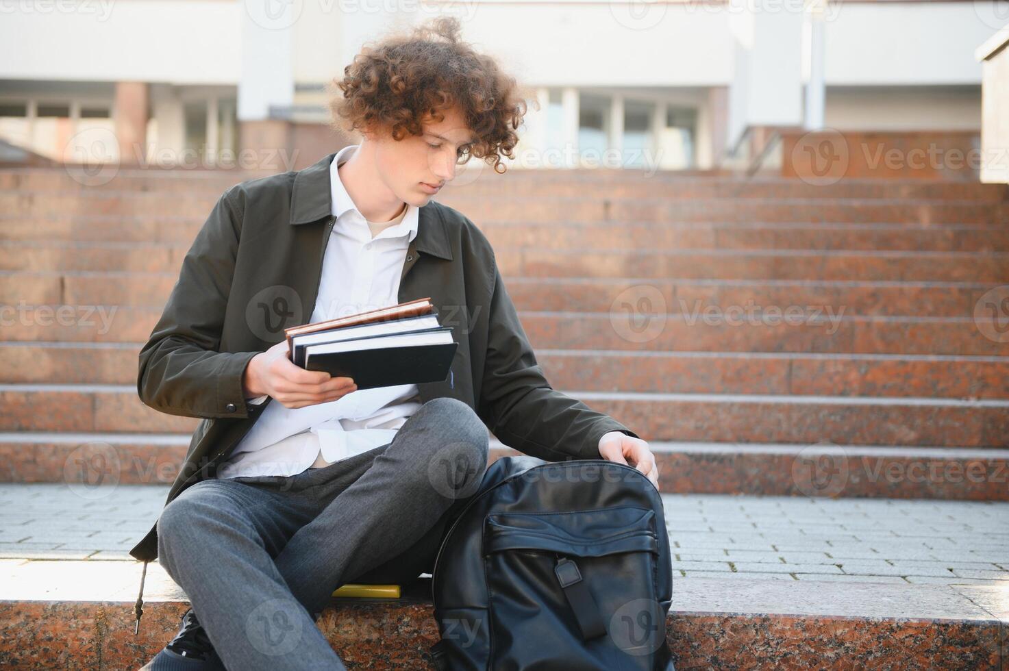 Excited student having break between classes near university, smiling to camera outdoors photo