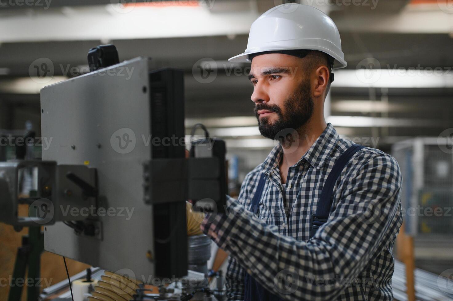 worker operating machine in factory photo