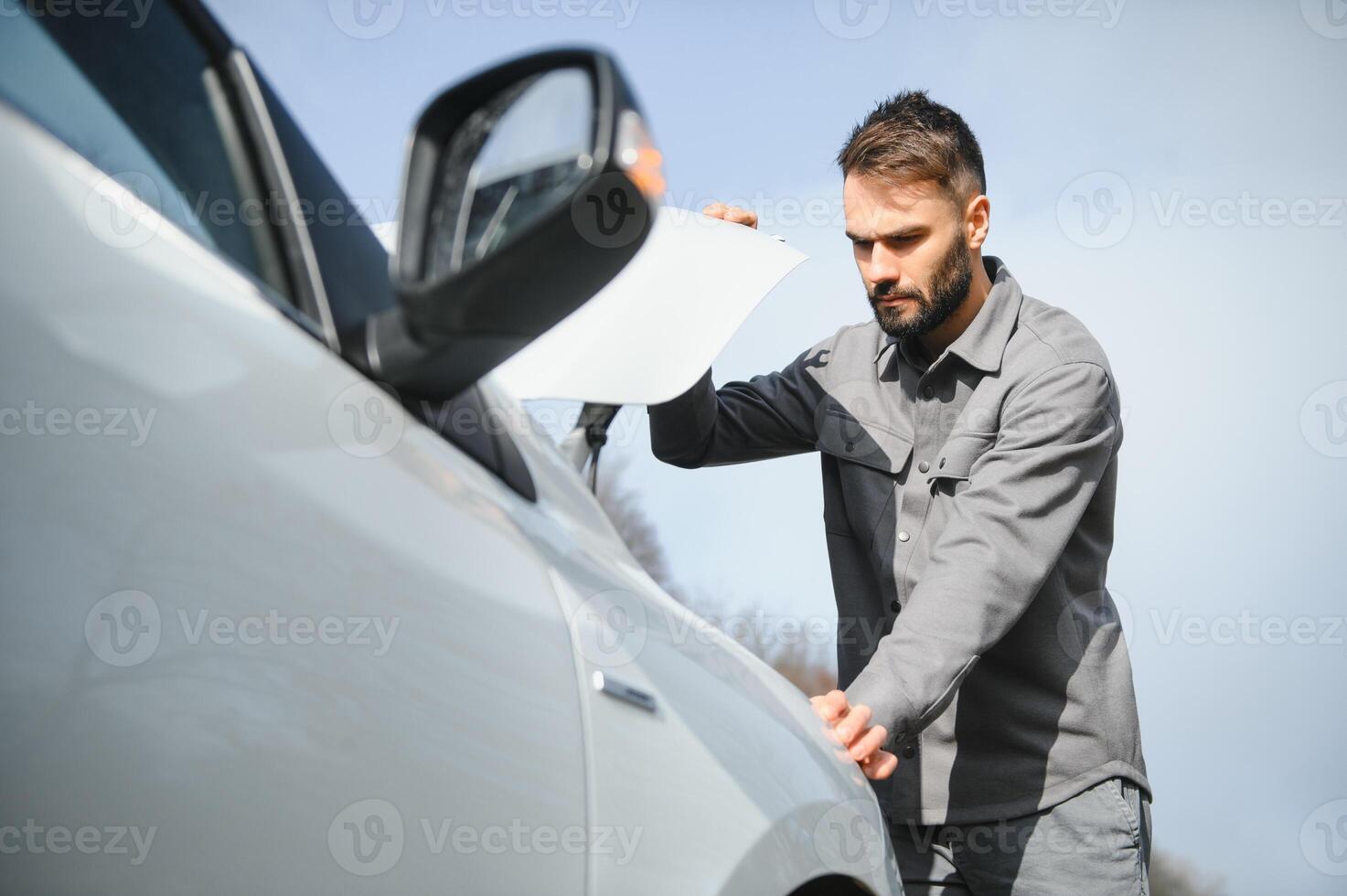 Close-up Of A Person Hand Signing Contract With Keys On It photo