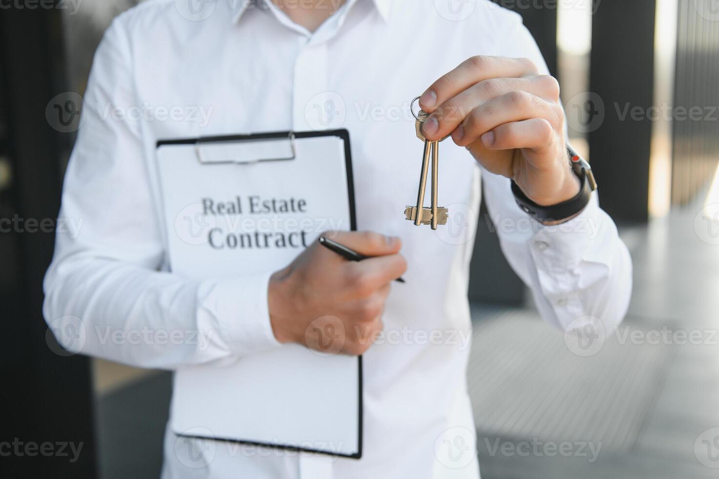 Professional estate seller with clipboard writing documents outside in front of rented house with advertising area photo