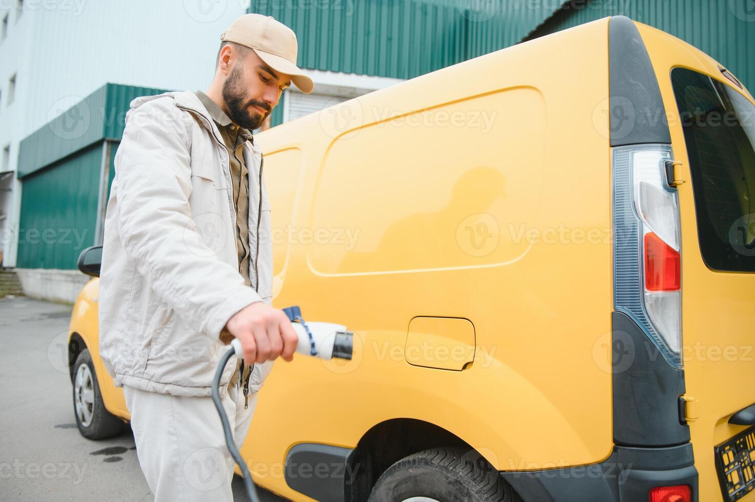Man holding power connector for electric car photo