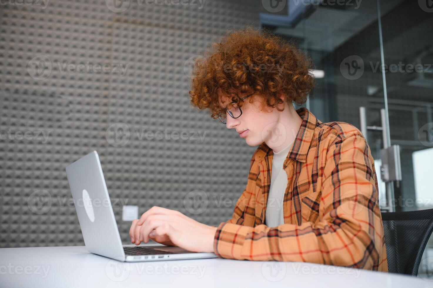 male programmer wear spectacles for eyes protection while working on freelance via laptop computer,clever student watching tutorial on netbook. photo