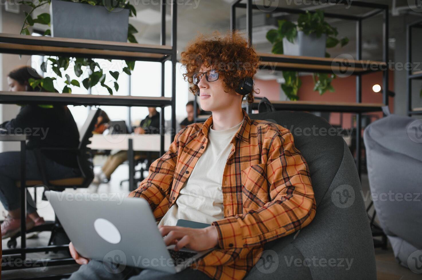 male programmer wear spectacles for eyes protection while working on freelance via laptop computer,clever student watching tutorial on netbook. photo