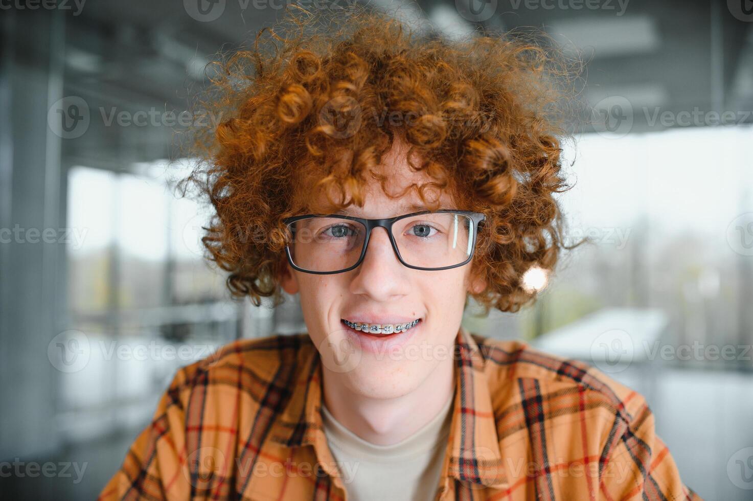 cute red-haired guy wearing stylish glasses yellow t-shirt. photo