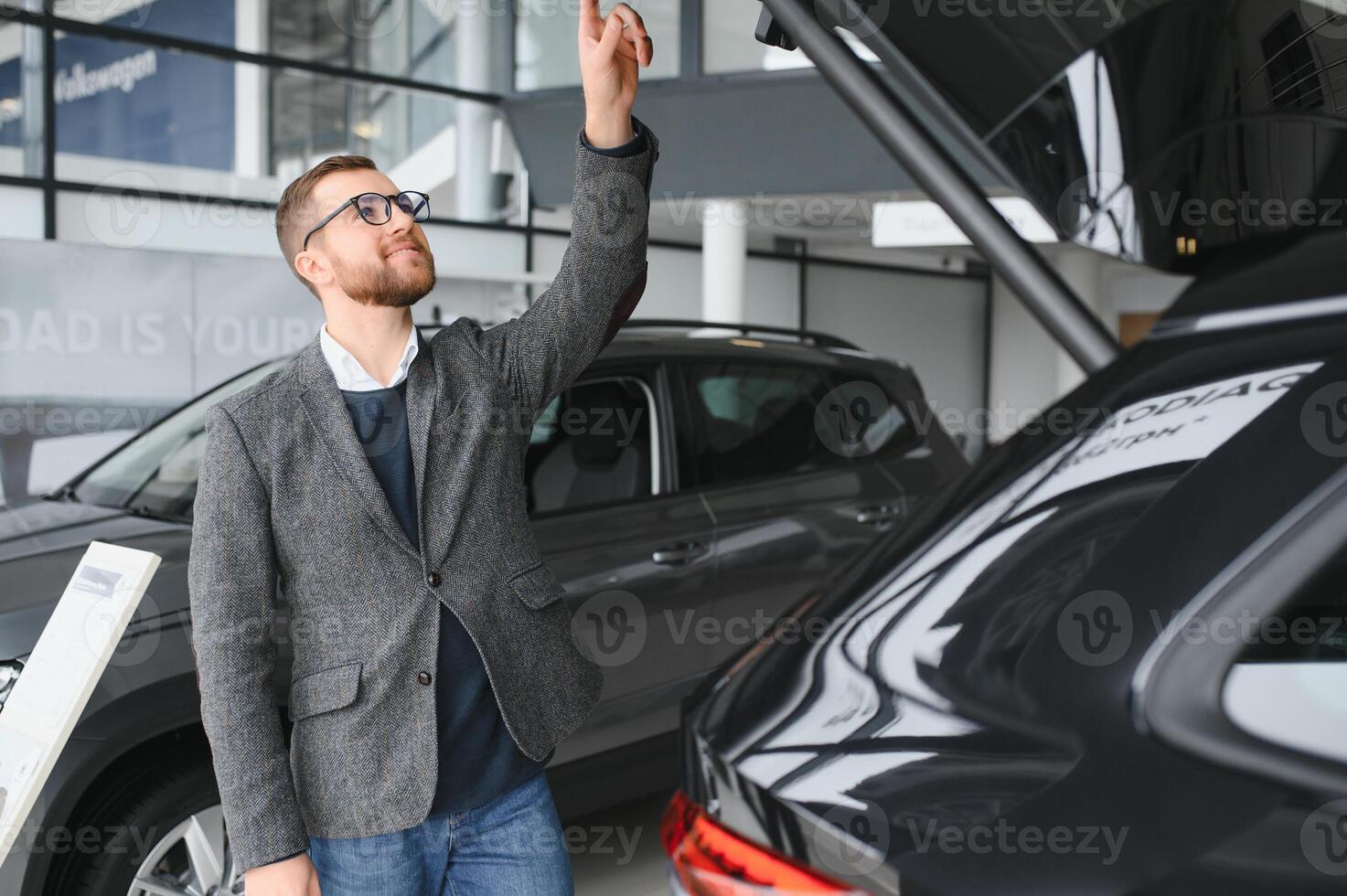 Man minded customer male buyer client in suit choose auto to go look aside want buy new automobile in car showroom vehicle salon dealership store motor show indoor Sales concept photo