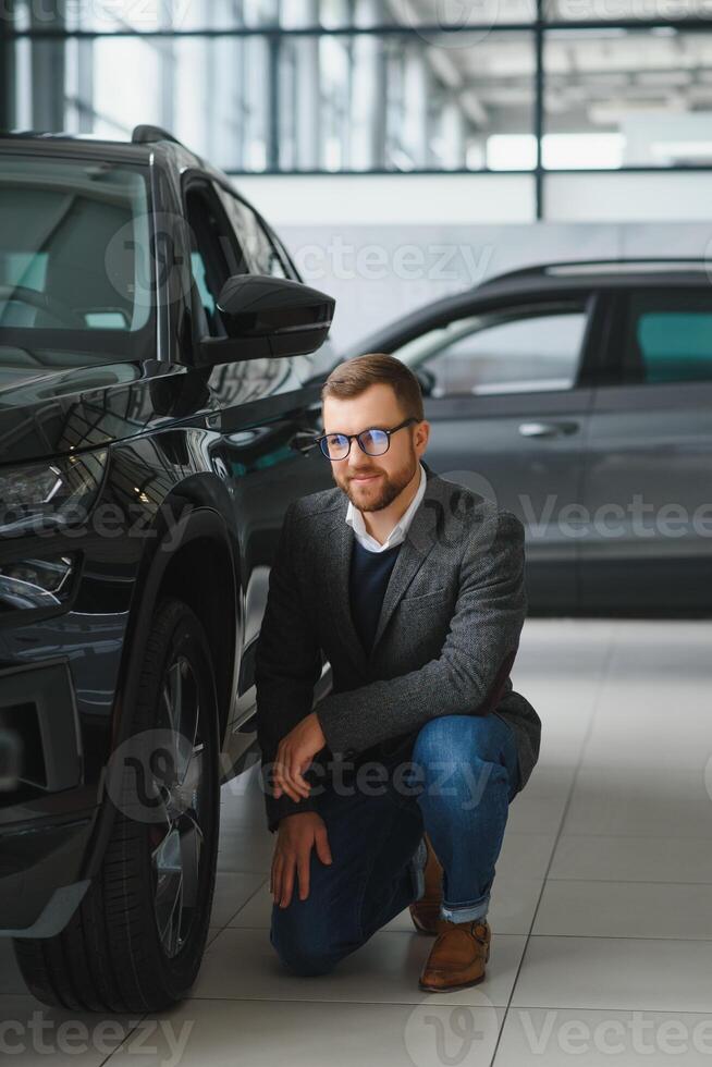 Man minded customer male buyer client in suit choose auto to go look aside want buy new automobile in car showroom vehicle salon dealership store motor show indoor Sales concept photo