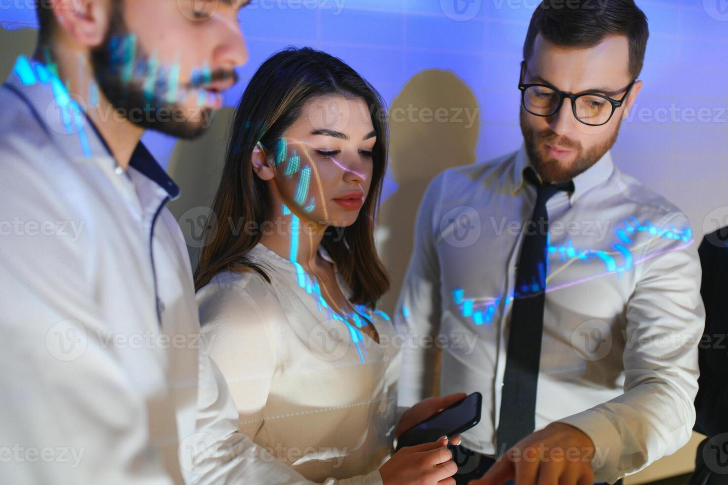 Group of business people working. Technical price graph and indicator, red and blue candlestick chart and stock trading computer screen background. Traders analyzing data photo