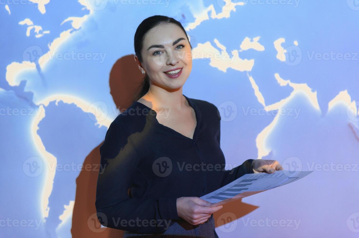 Globe business concept - happy business woman with world map background. photo